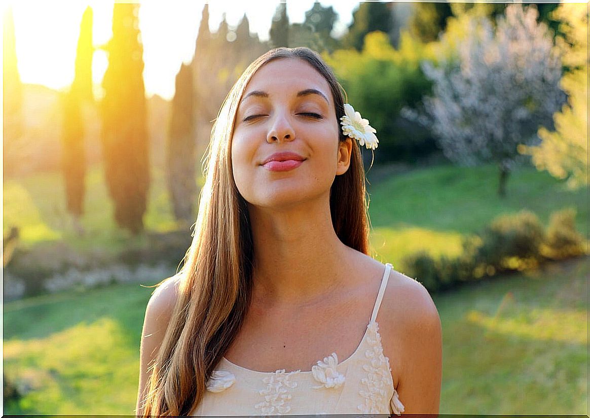 Woman with closed eyes and a flower in her hair