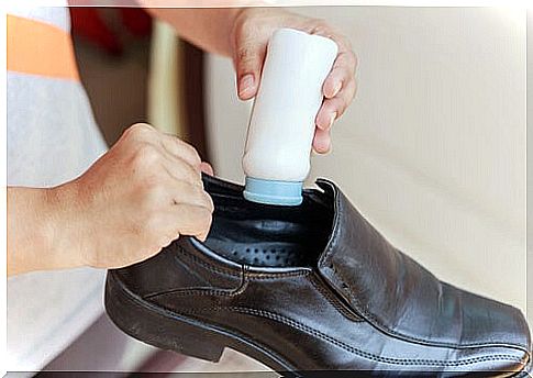 Woman putting powder on shoes