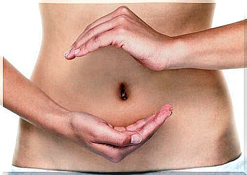 Woman with hands on abdomen