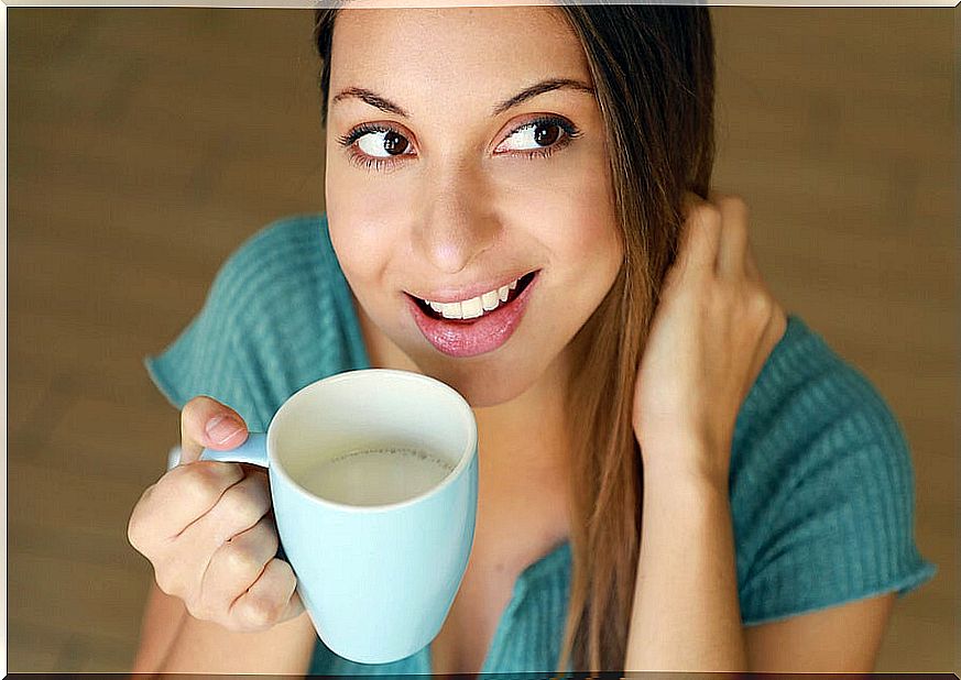 Woman drinking milk from a cup.