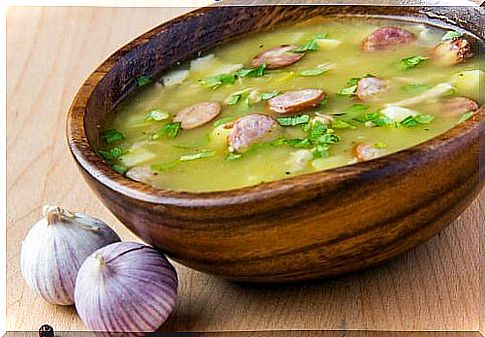 Garlic soup in wooden bowl