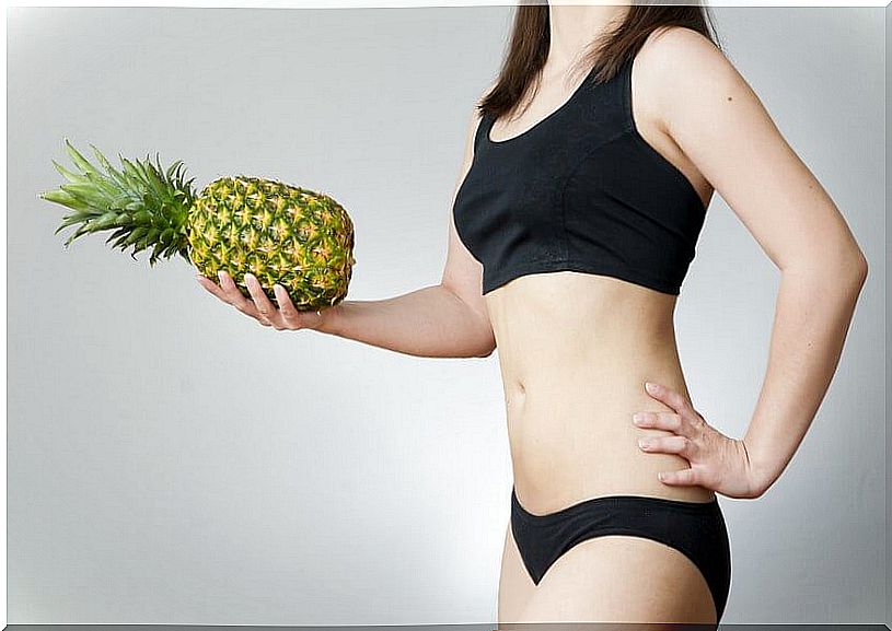 Woman holding a pineapple.