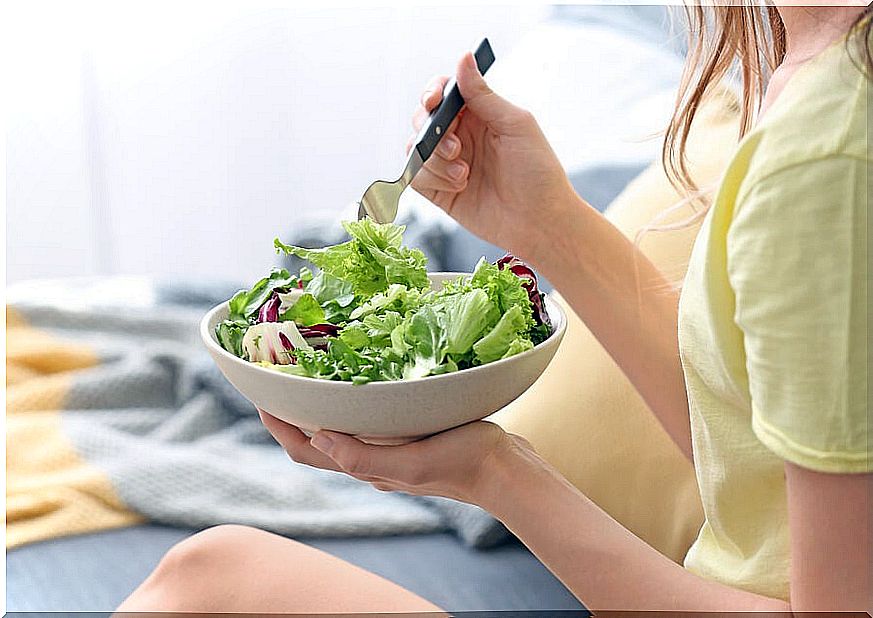 Woman eating vegetables