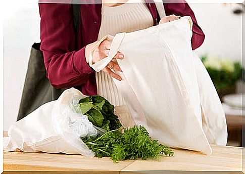 Woman taking shopping out of a cloth bag