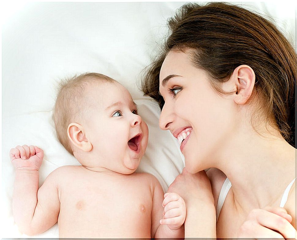 New mother with her baby laughing.