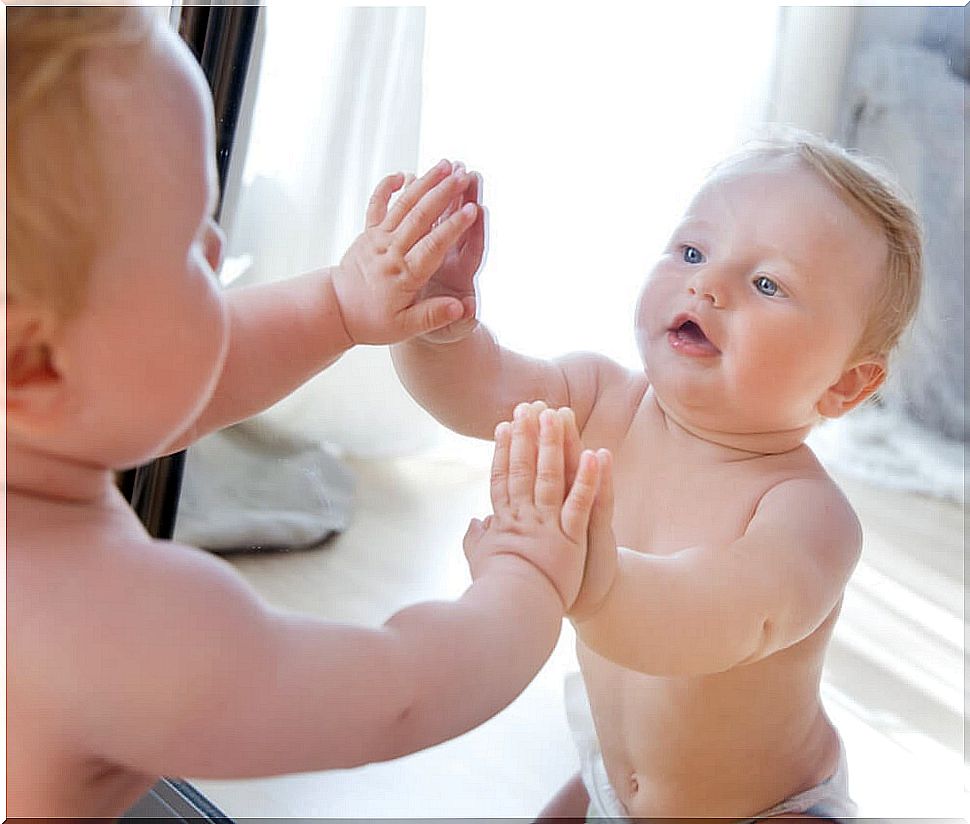 Baby in front of a mirror.