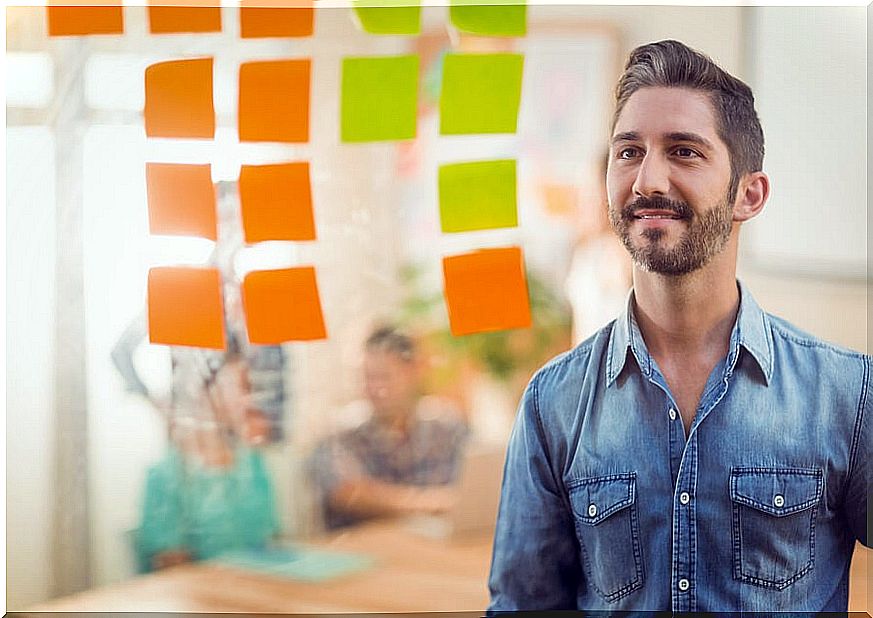 Man looking at a panel with post its