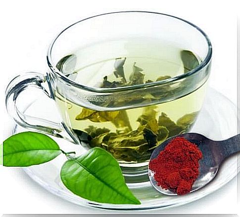 Cup of green tea with red pepper