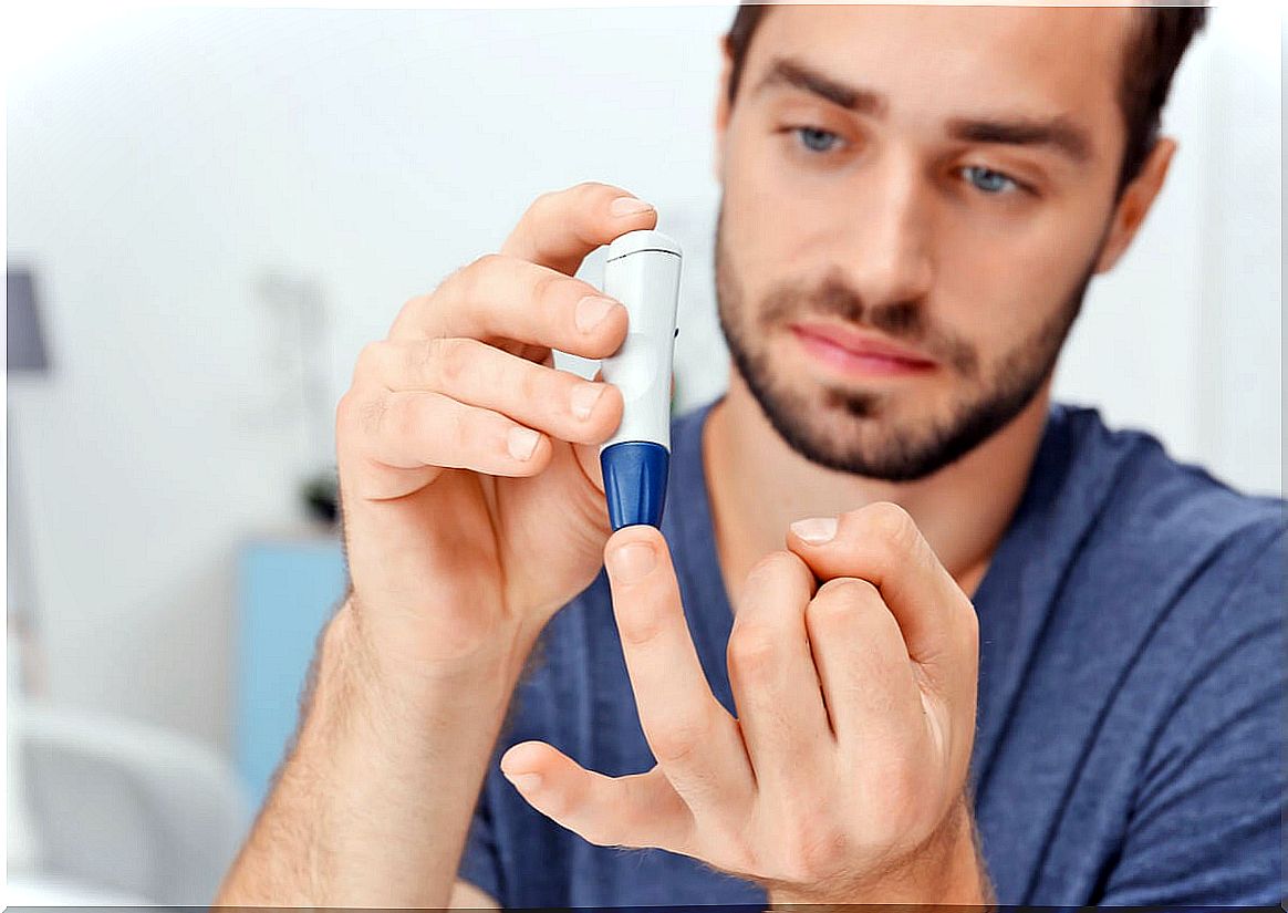 Man with diabetes measures his glucose.